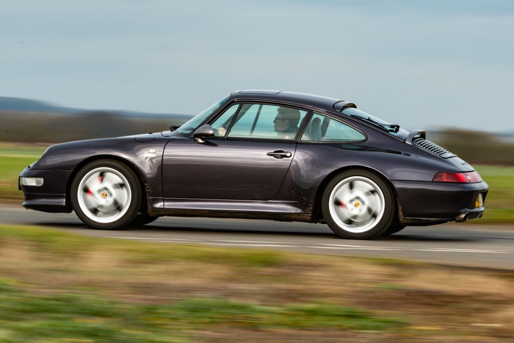 Porsche 993 driving on the road.